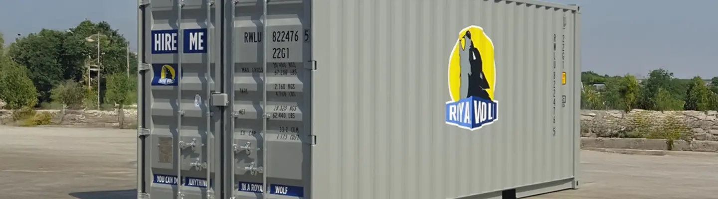 A 20ft grey shipping container with Royal Wolf branding placed in an outdoor industrial setting.