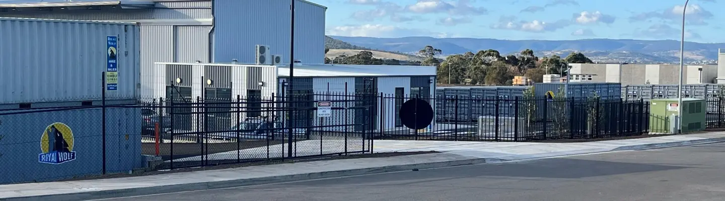 New self-storage facility with multiple storage units and secure gated access, representing expanded community storage solutions.