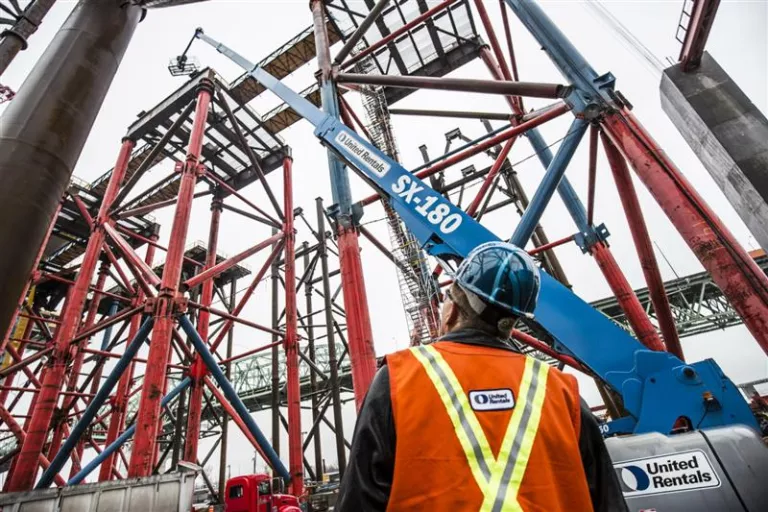 Man at job site looking at Equipment