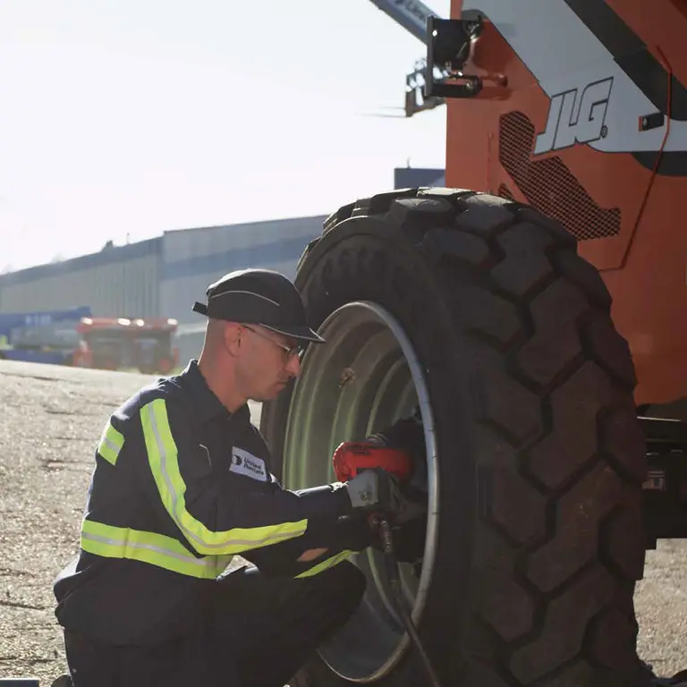 United Rentals employee doing maintenance on equipment