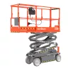 Side angled view of a retracted orange Skyjack scissor lift with safety rails.