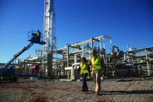 Construction managers in front of power plant