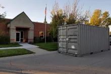 Storage container sitting in front of a building